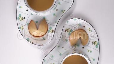 两杯绿茶在白色桌子上旋转。 茶杯从上往下看，在漂亮的餐具与传统的餐桌旋转